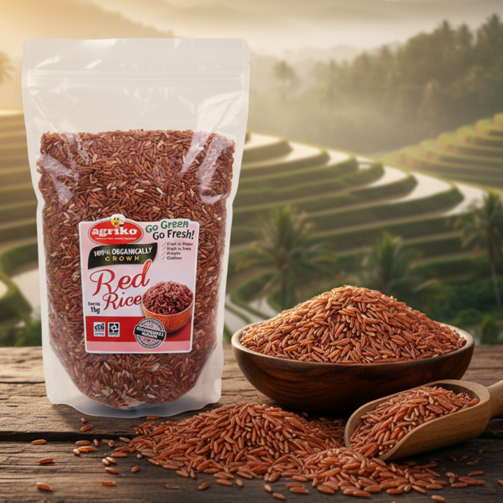 Bag of Agriko Red Rice with a bowl and scoop on a wooden surface, set against a scenic background.