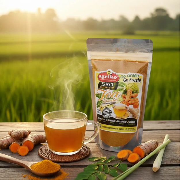 5n1 Turmeric Tea Powder Blend package beside a prepared cup and turmeric roots